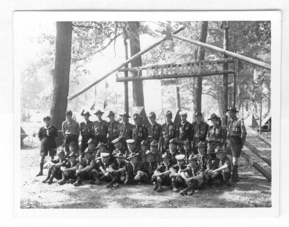 A group of Scouts by the gate of their campsite